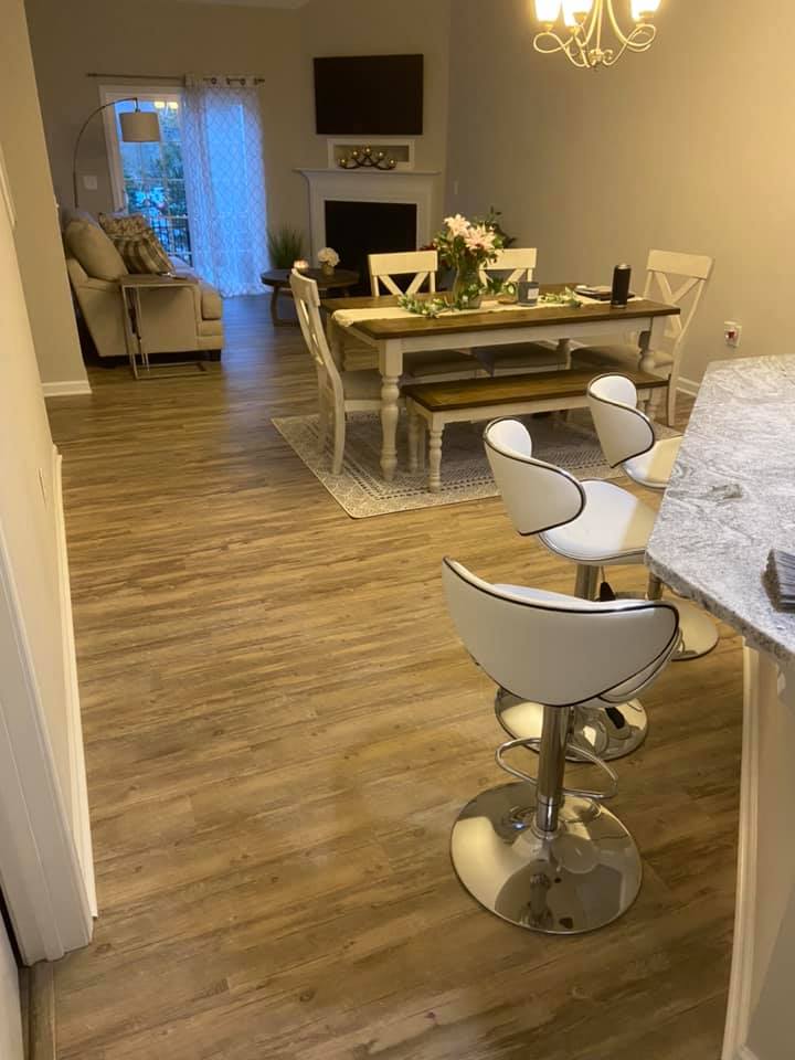 Hardwood floor installation in open-concept living room by His Handy Hands
