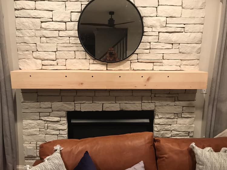 Stone fireplace with wooden mantel installation by His Handy Hands